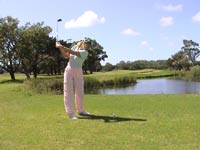 Swing over water hazard at golf course during golf holiday at Kap Vino Estate
